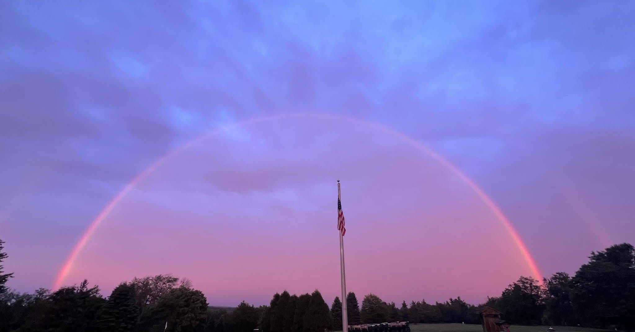 A full rainbow over the course at dusk
